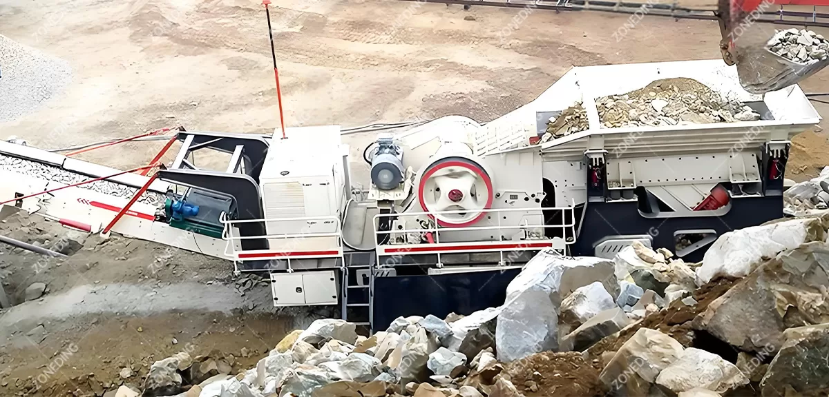 A-mobile-mounted-mobile-jaw-crusher-performing-primary-crushing-of-large-ore-blocks-at-a-mine-site